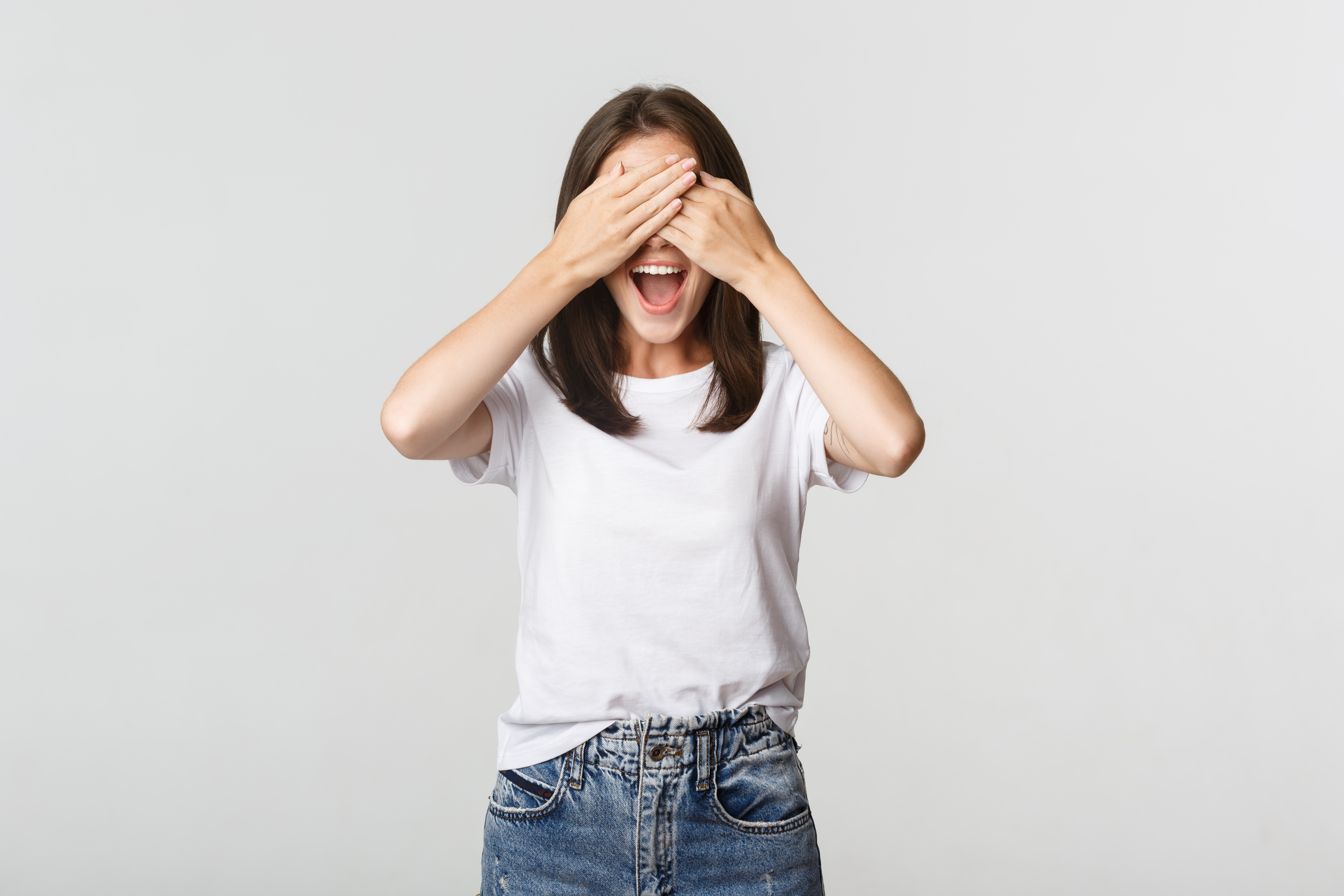 Cheerful smiling woman shut eyes and expect surprise